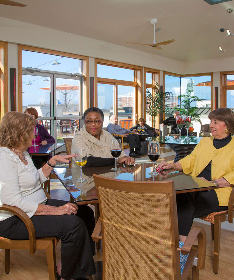 Residents enjoying a glass of wine together in of our restaurant-style dining rooms at All Seasons Oro Valley in Oro Valley, Arizona