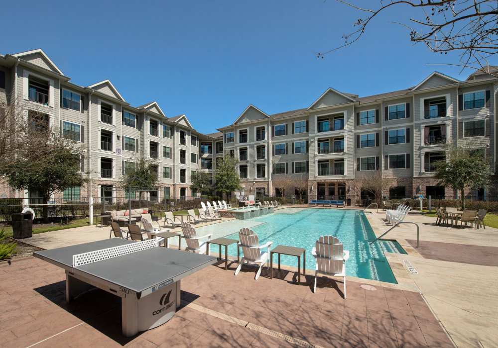 Apartment community swimming pool with pool table at Nantucket at Fannin Station in Houston, Texas
