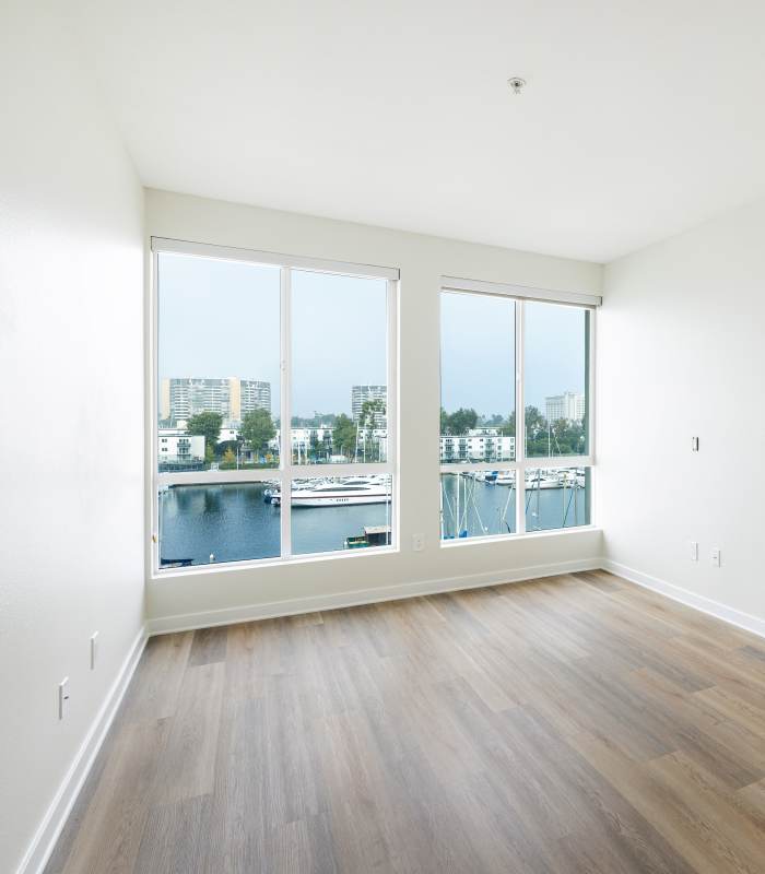 Bright living space with water views at Capri Apartments in Marina Del Rey, California.