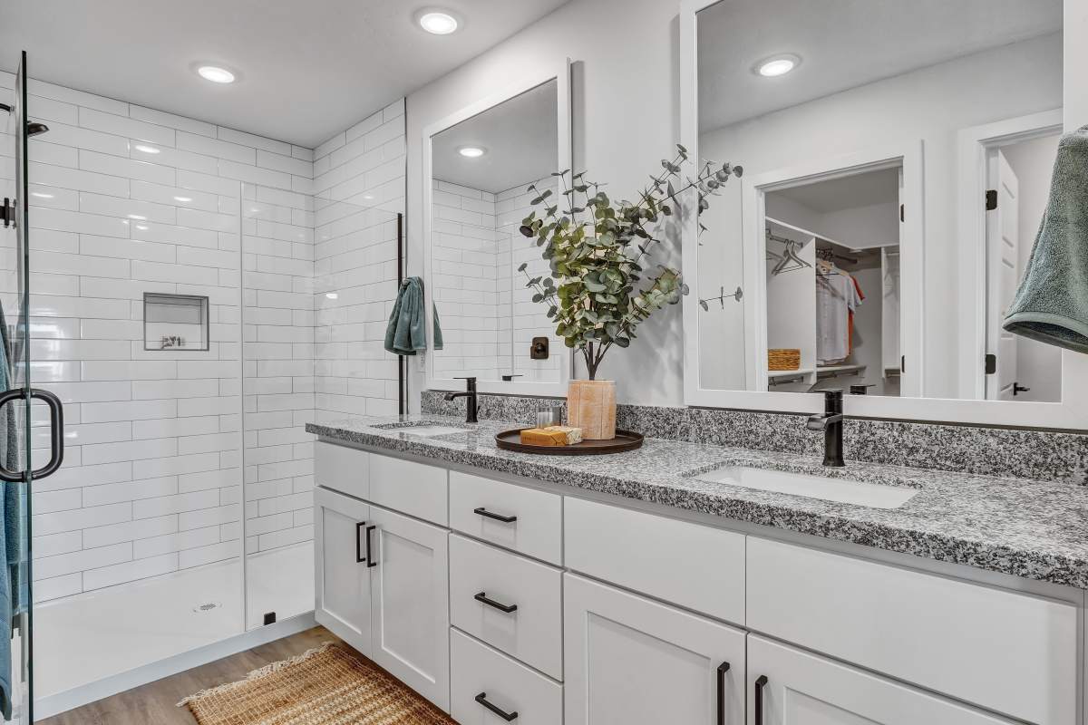 Primary bathroom featuring double vanity & walk-in shower at BB Living at The Oaks in Meridian, Idaho