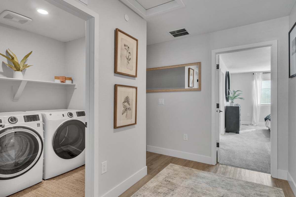 Landing featuring full size washer & dryer inside the laundry room 