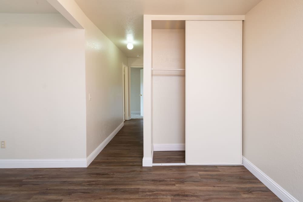 Living room at with hardwood-style floors at Peppertree Apartment Homes, in San Jose, California.