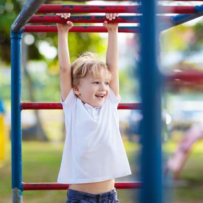 Kid playing on playground at The Enclave at Bear Creek in Euless, Texas