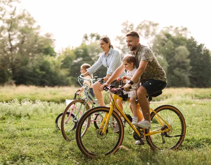 Family enjoying their time by riding bicycle in the park near Chatham Grove Apartments in Chicago, Illinois