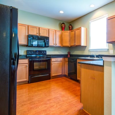 A kitchen with stainless steel appliances at Heroes Manor in Camp Lejeune, North Carolina