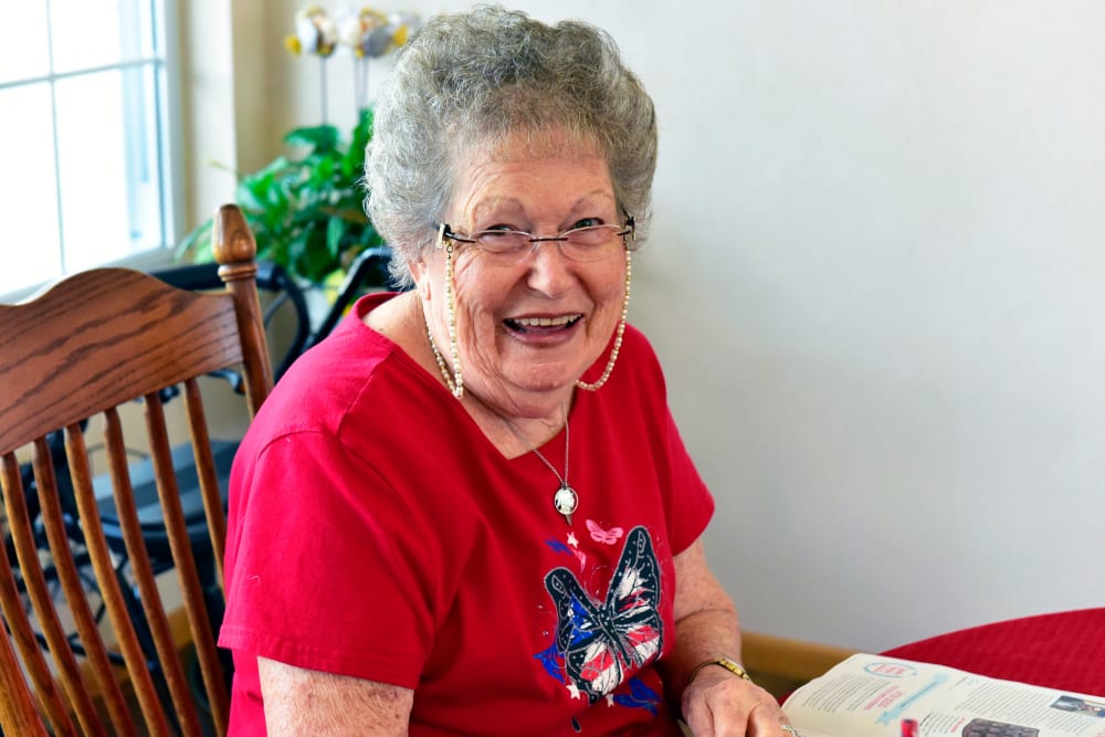 Happy resident sitting in her home at Garden Place Millstadt in Millstadt, Illinois