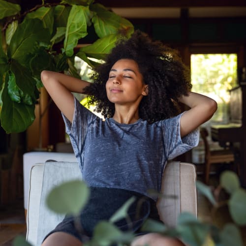 Woman sitting on a chair stretching out at Magnolia Court in Orlando, Florida