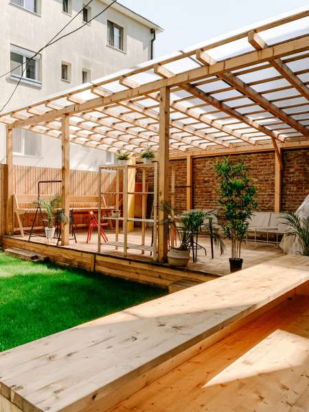 a backyard porch with awning overhead 