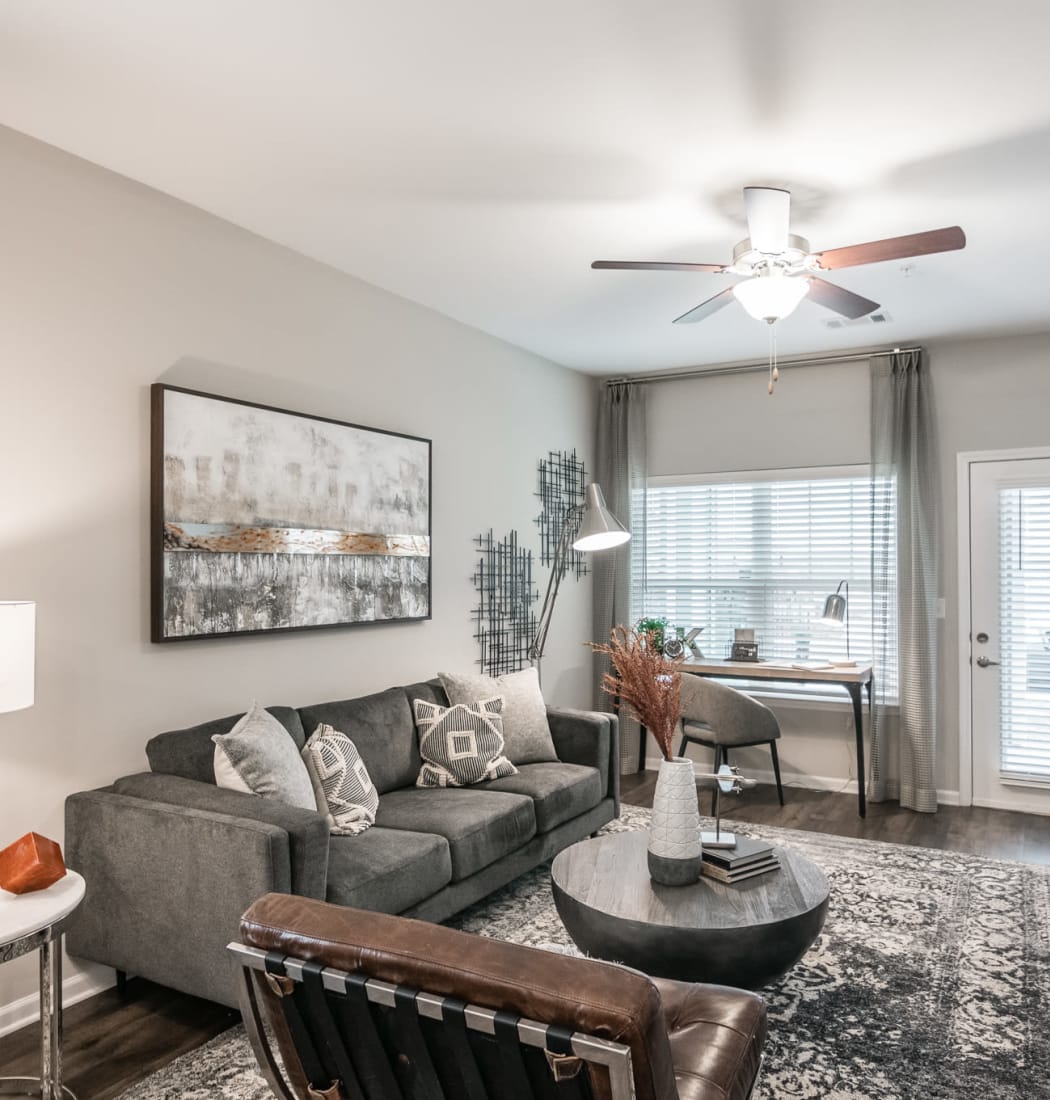 Modern styled living room with tons of natural light at Kirkwood Place in Clarksville, Tennessee