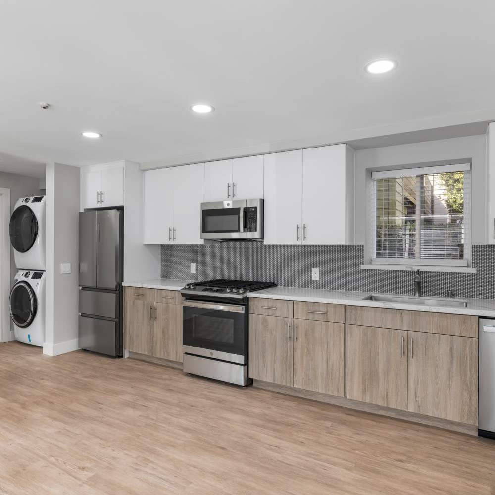 Modern kitchen with laundry facility at Crossbrook Apartments in Rohnert Park, California