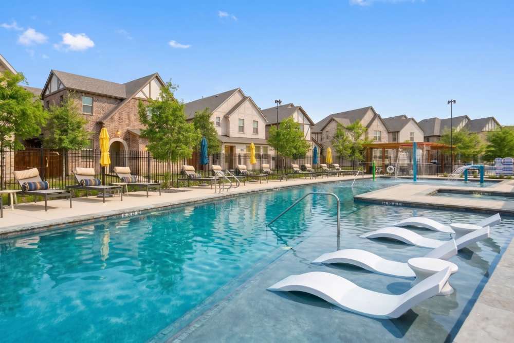 Luxury Pool With Lounging Chairs at BB Living The Tribute in The Colony, Texas
