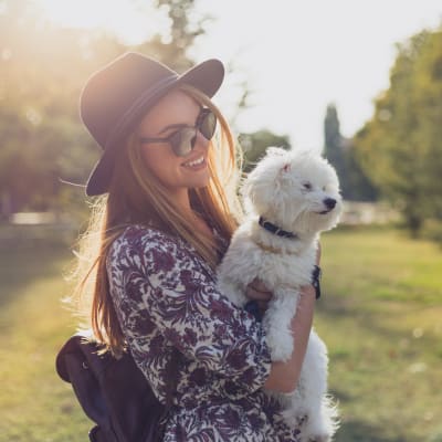 Resident holding her dog near Sofi Parc Grove in Stamford, Connecticut