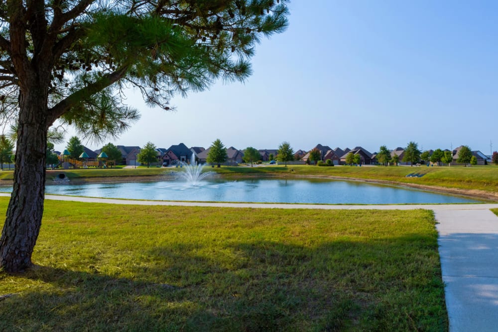 View of the pond from a walking trail at Village on the Park Bentonville in Bentonville, Arkansas