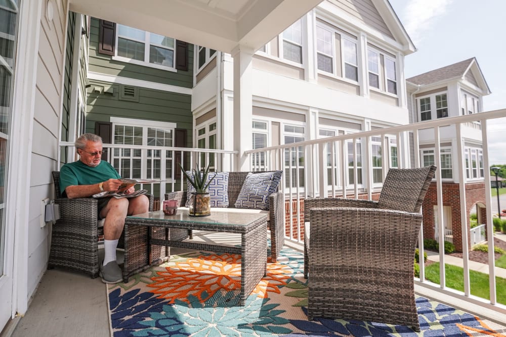 Resident sitting on their balcony Harmony at Independence in Virginia Beach, Virginia