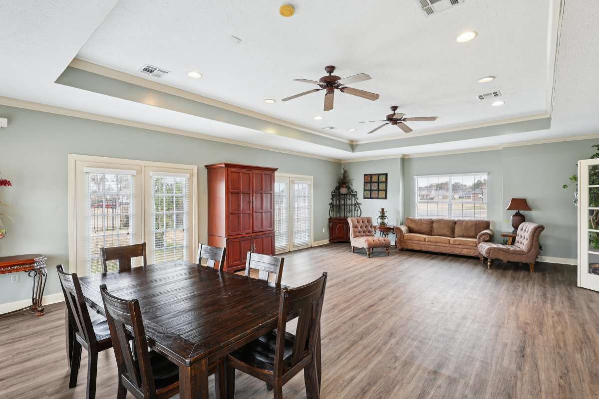 Community clubhouse with dining table and large couch at Camden Park in Canton, Mississippi