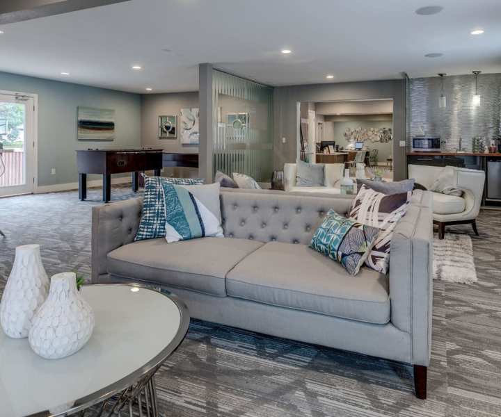 Community clubhouse with kitchen and couch at Renton Sage in Renton, Washington