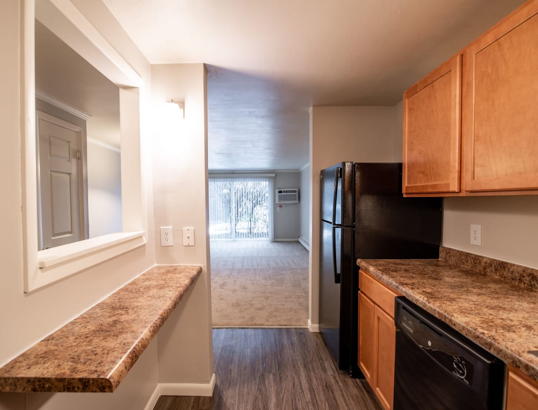 Village Green Apartments offers a naturally well-lit living room in Baldwinsville, NY