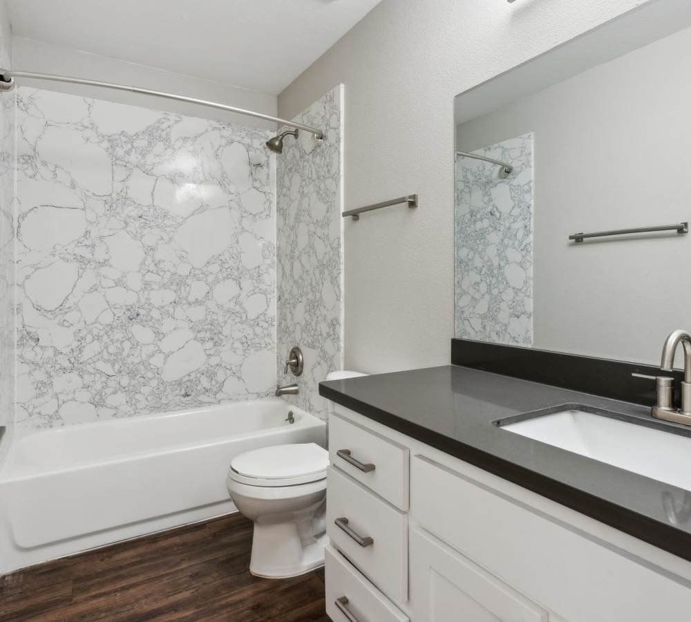 Bathroom with white cabinets and quartz counters at Muirwood Apartment Homes in Martinez, California