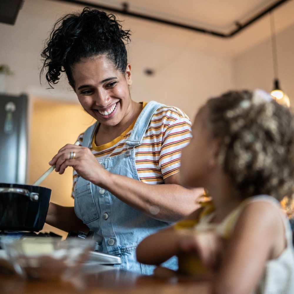 Resident and her child in kitchen of their apartment at Townsend Trace Apartments in Greensboro, North Carolina