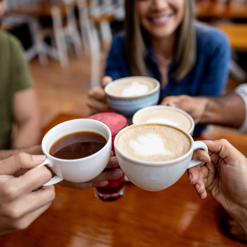 Residents having coffee at a cafe near The Pines At Peach Road in Raleigh, North Carolina