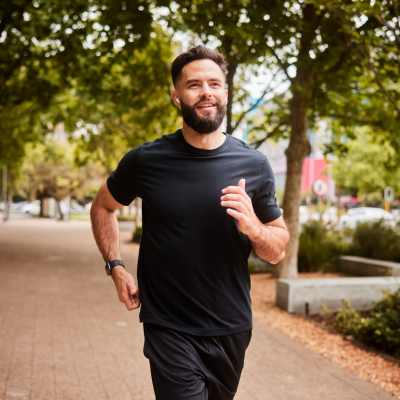A resident jogging in park near The Village At Bellaire Apartments, Houston, Texas