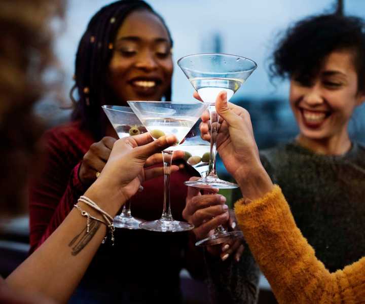 Resident women's clinking their wine glasses together near Magnolia Terrace in Tallahassee, Florida