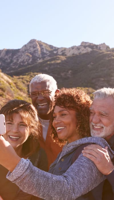 Couples pausing for a group selfie on a hike through the foothills near our Village Green Senior community at Mission Rock at Sonoma in Sonoma, California