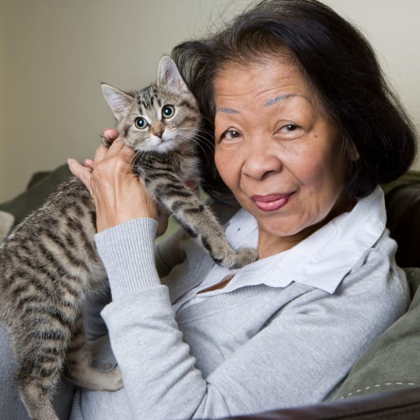 Resident holding a kitten at Pacifica Senior Living Ellensburg in Ellensburg, Washington