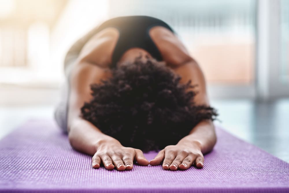 Resident doing some yoga in her home at Briarwood Apartment Homes in Livermore, California