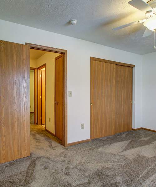 Carpeted floor with two wooden doors at Wellington Place in Ottawa, Ohio