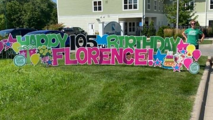105th Birthday sign on a lawn at Water