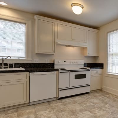 A kitchen with white cabinets and a dishwasher Broadmoor in Joint Base Lewis-McChord, Washington
