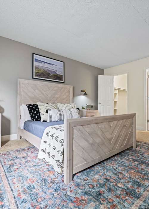 Spacious bedroom with a comfortable bed and a walk-in closet at Windsor Court and Tower in Silver Spring, Maryland