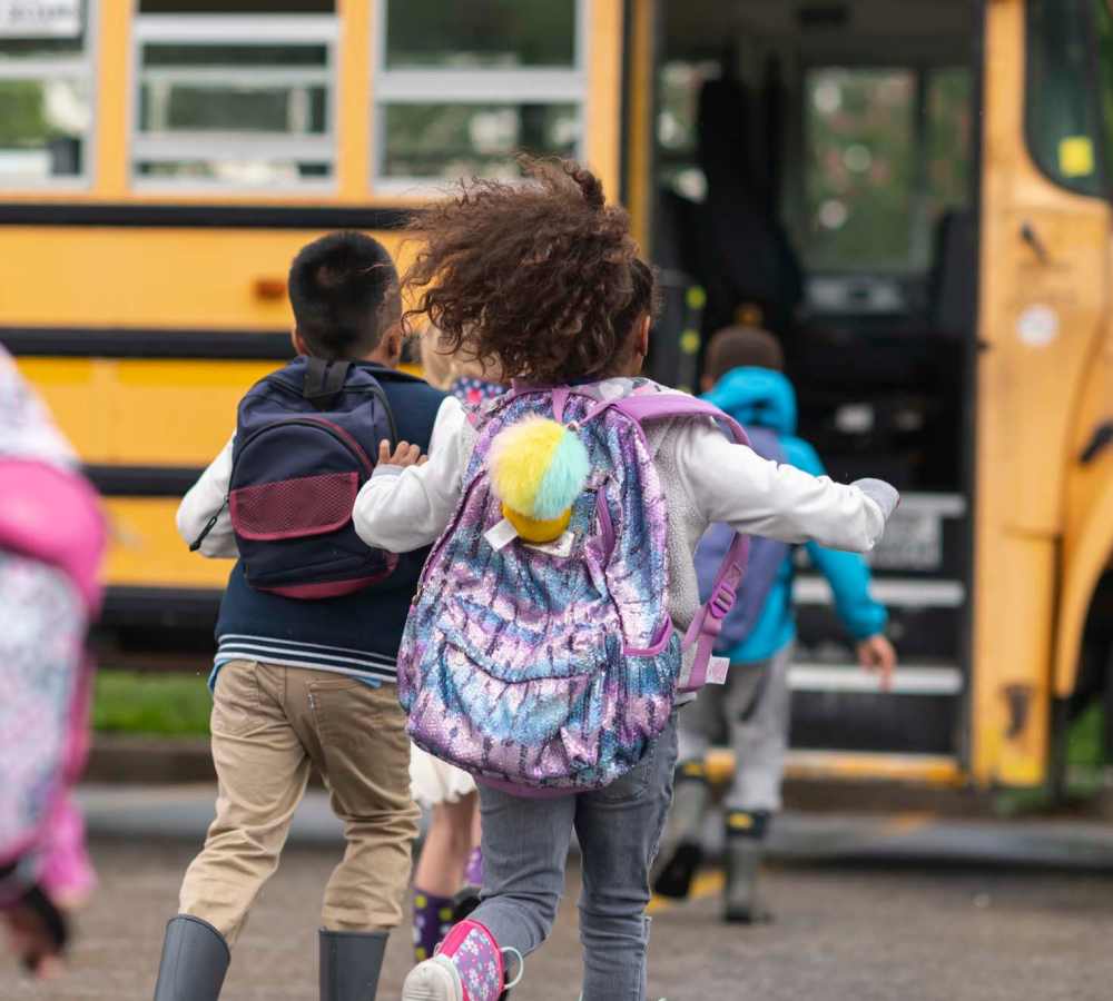 Resident children boarding bus near Avia Lofts at Maple Road in Amherst, New York