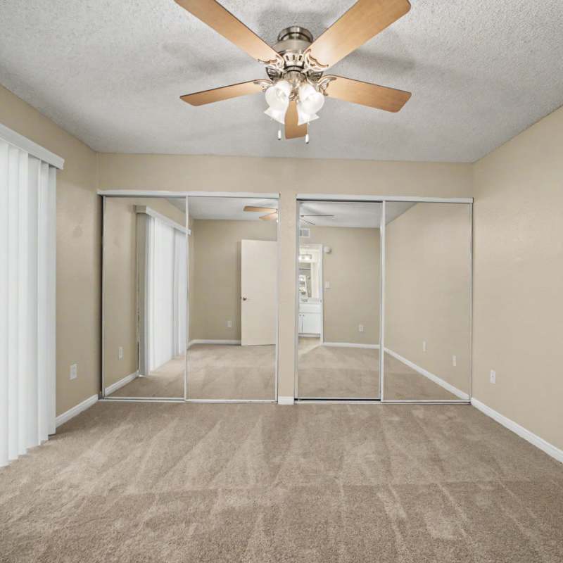 Bedroom with an extra-large mirror closet at Westlake Village in Costa Mesa, California