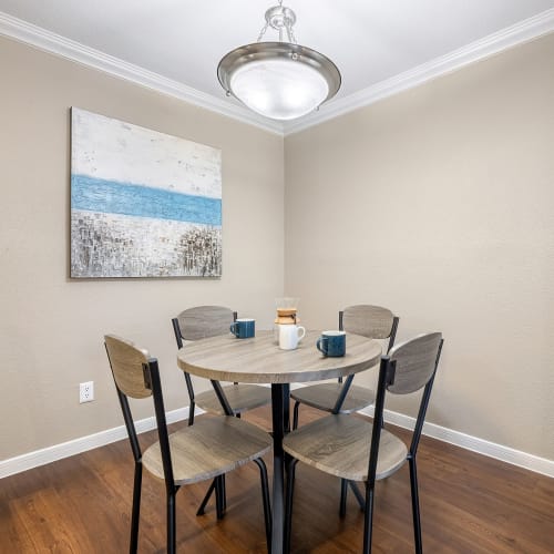 Dining table with chairs in corner with round light above at Austin Midtown in Austin, Texas