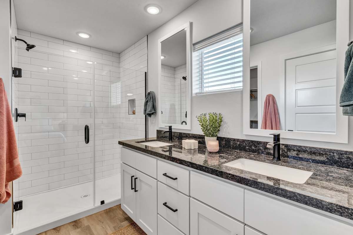 Primary bathroom featuring double vanity & walk-in shower at BB Living at The Oaks in Meridian, Idaho