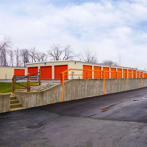 Row of outdoor storage units with red doors at Red Dot Storage in Gurnee, Illinois