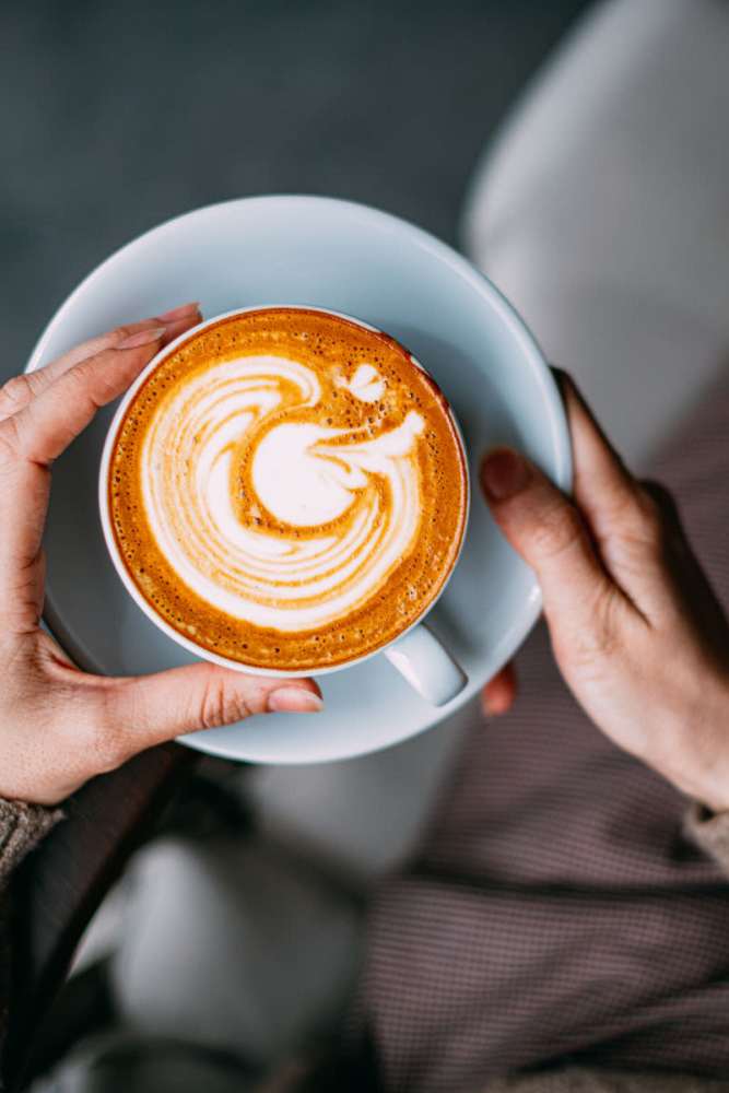 Resident drinking coffee at Village Center Senior Apartments in Anaheim, California