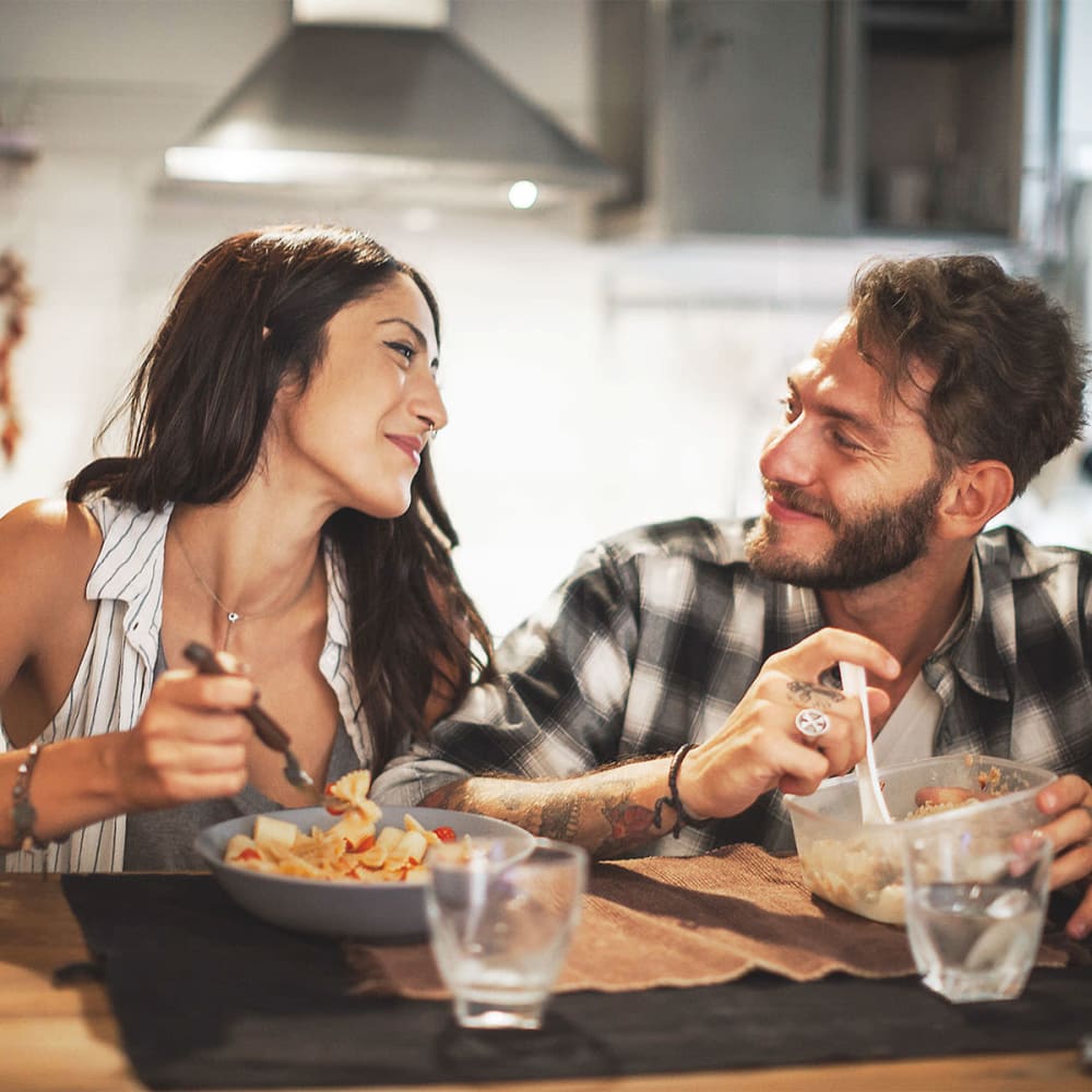 Resident couple eating dinner in their kitchen at our Redwood Manor community at Mission Rock at Sonoma in Sonoma, California