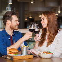 A happy couple having drink in restaurant near Avenues at Tuscan Lakes in League City, Texas