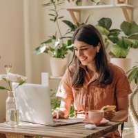 Woman using online resident portal at Cross Timbers At Grand Street in Amarillo, Texas