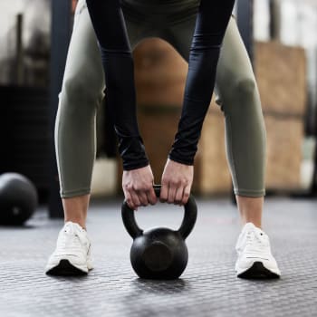 A woman lighting a weight in the fitness center at Cypress Creek Parker Boulevard in Royse City, Texas