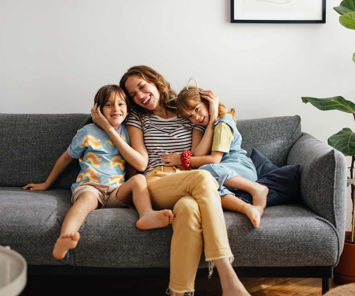 Family enjoying cozy living room together at Apperson Way Apartments in Kokomo, Indiana 