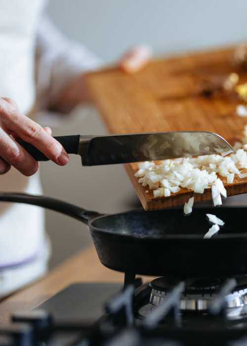 Resident cooking in kitchen at Textile Lofts at Planet Zero in Richmond, Virginia