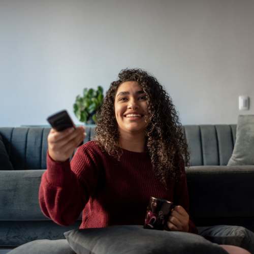 Resident watching TV at Riverwood Apartments in Reno, Nevada