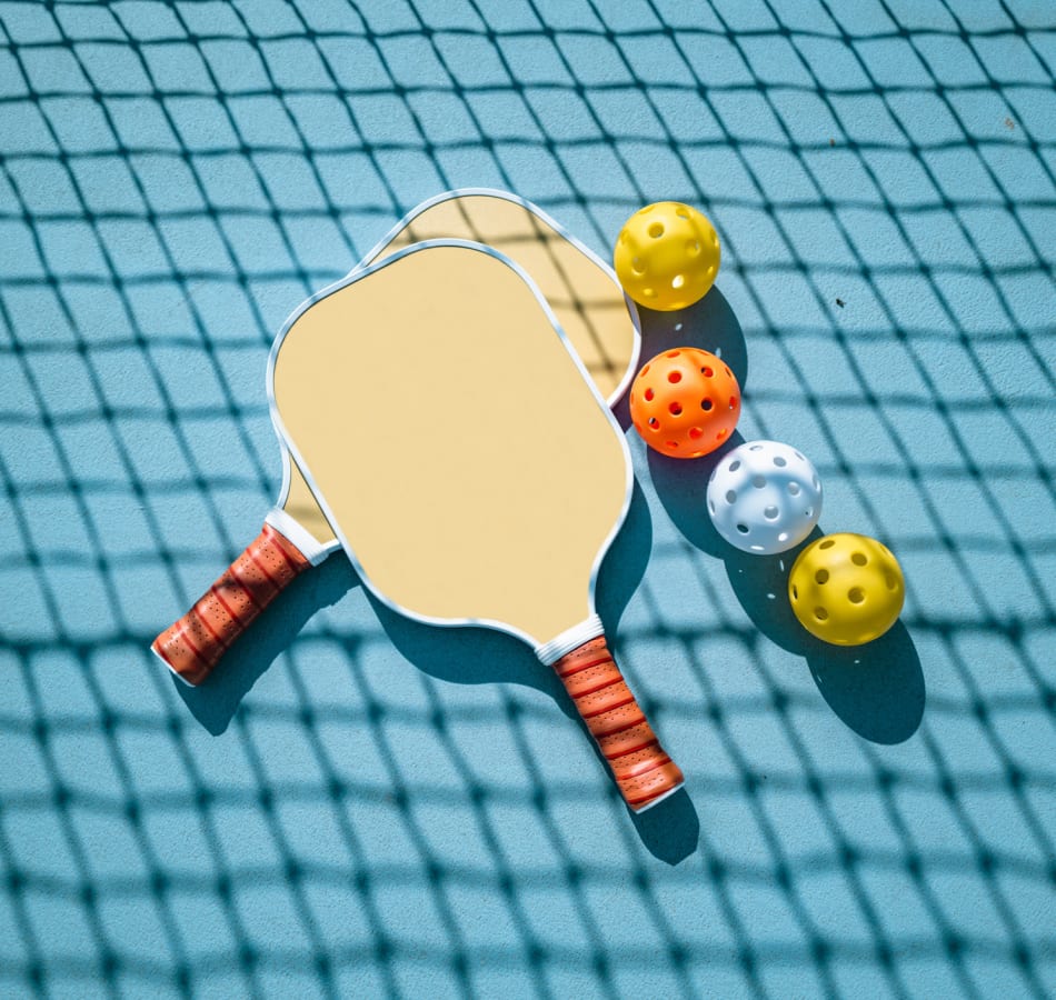 A racket and balls on the ground at The Vivien in Vero Beach, Florida