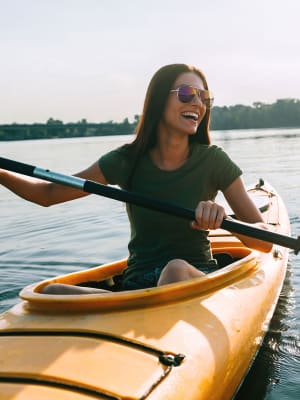 A woman enjoys getting out on the water in her kayak near M2 Apartments in Denver, Colorado