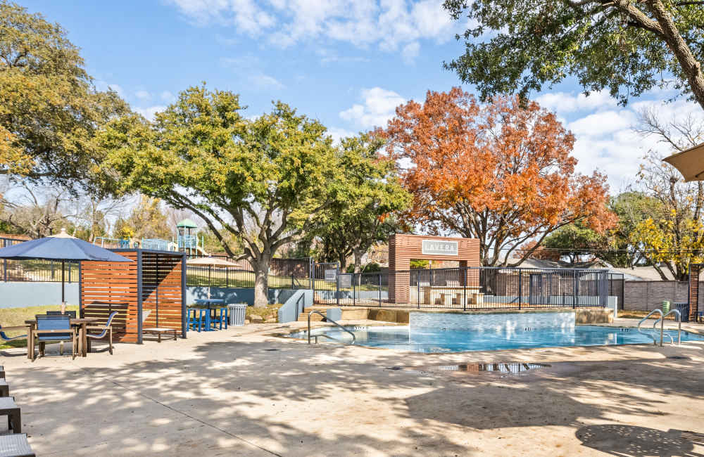 Pool area with lounge seating at Lavera At Lake Highlands in Dallas, Texas