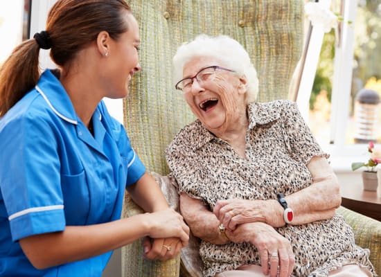 Staff nurse and resident share a joke at Westminster Memory Care in Lexington, South Carolina